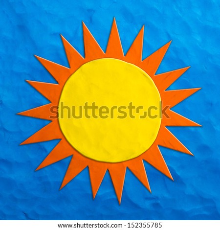 Color children's sun plasticine on a blue background 