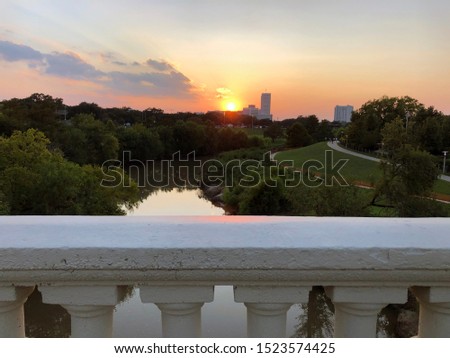 A warm sun is setting over Buffalo Bayou in Houston Texas 