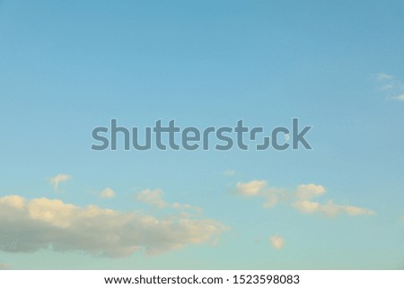 Blue summer sky background. Small half of moon