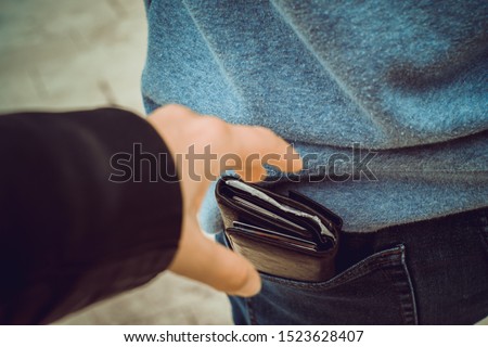 Stealing wallet from the back pocket, Pickpocket Royalty-Free Stock Photo #1523628407