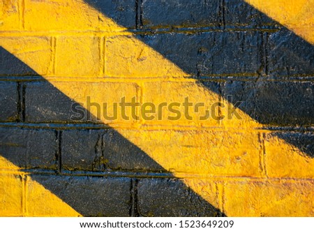 Warning background with yellow and dark stripes. Concept image for caution, danger and hazard. Texture and background image.