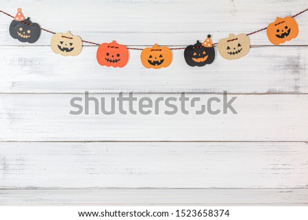 Halloween pumpkins decoration over white wood background.