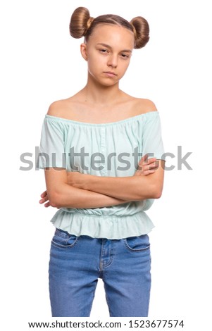 Portrait of confident teen girl posing with crossed arms. Child with hands folded looking at camera. Emotions and signs concept. Young student isolated on white background.