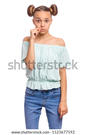 Portrait of teen girl showing sign of closing mouth and silence gesture. My lips are sealed. Child showing zip gesture as if shutting mouth on key. Funny teenager isolated on white background.