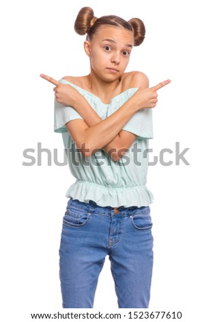 Portrait of teen girl crosses hands over chest and pointing index fingers in different sides or directions, cant make choice. Child pointing fingers. Beautiful teenager, isolated on white background.