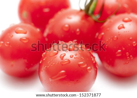 Fresh ripe cherry tomatoes scattered isolated on white background