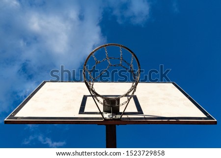 A basket to play basketball in the school playground. School playground equipment. Autumn season.