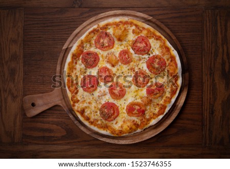 Fresh tasty pizza Margarita on wooden background
