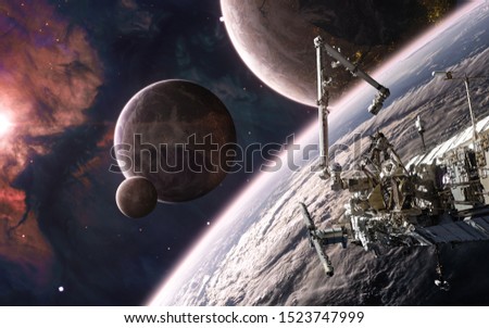 Beautiful cosmic landscape in warm starlight. Space station on background of colonized planets. Science fiction. Elements of this image furnished by NASA
