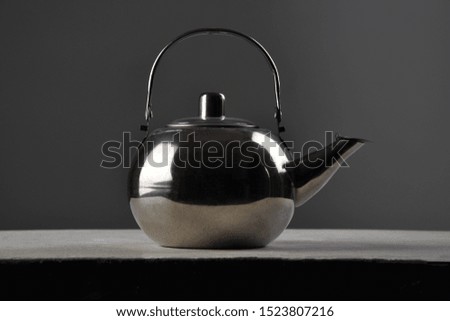 Iron kettle on the table on a gray background