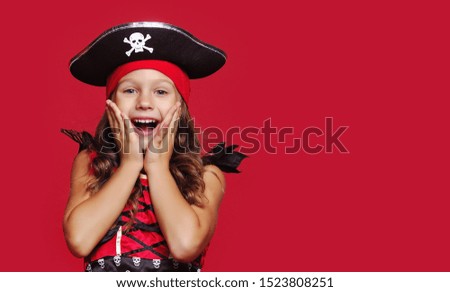 Close-up portrait of surprised girl dressed as pirate