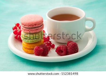 Colorful macarons with a cup of tea