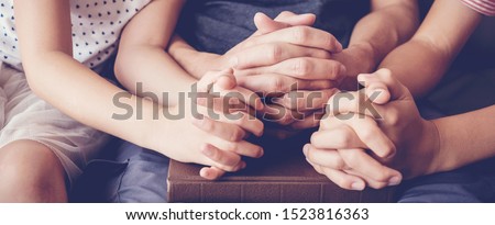 children praying with parent at home, family pray together, online group worship, World Day of Prayer,international day of prayer, hope, gratitude, thankful, trust Royalty-Free Stock Photo #1523816363