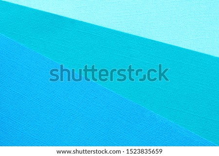 Abstract background and texture of three blue paper in different shades.

