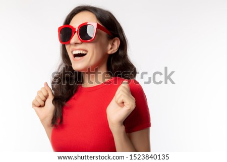 Portrait cheerful woman. Attractive beautiful young woman wears sunglasses, red t shirt with smiley face. Gorgeous girl get happiness when summer season coming, it’s time for traveling to nice place