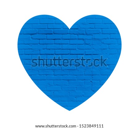Blue love heart on a white brick wall background. Neutral texture of a flat brick wall close-up.