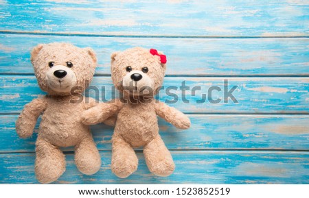 Teddy bear on wooden background.