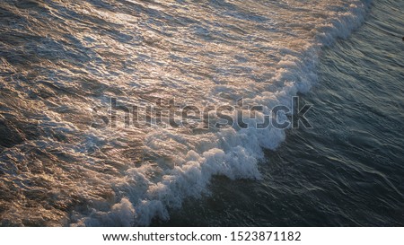 waving int ocean and sunlight hit the water