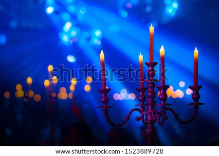 Abstract Candles that are set in front of the dark blue.blurred,soft focus,motionblur.