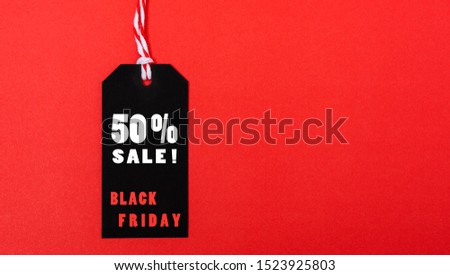 Online shopping, Promotion Black Friday Sale 50% text on black tag on red background.