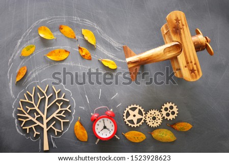 Education concept, banner of vintage airplane on a chalkboard with fall leaves