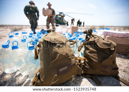 Delivery of humanitarian aid by military helicopter Royalty-Free Stock Photo #1523935748