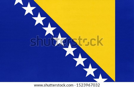 Bosnia and Herzegovina national fabric flag textile background. Symbol of international world european country. State official europe sign. Royalty-Free Stock Photo #1523967032