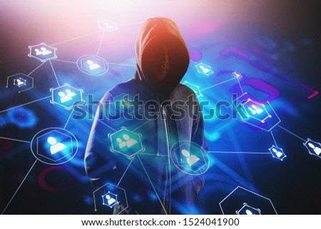 Unrecognizable young hacker standing over blurry background with double exposure of social media interface. Concept of cyber security and data protection. Toned image