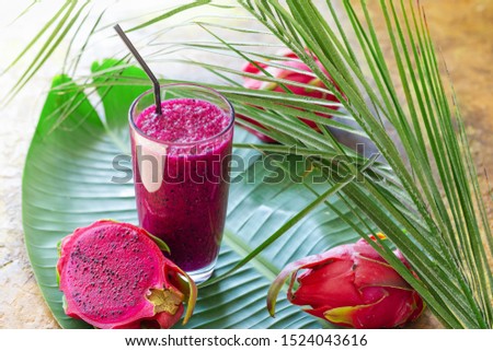 Red dragon fruit sliced and smoothie juice in a glass 
