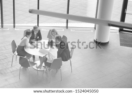 Black and white photo of bussiness people on meeting in office