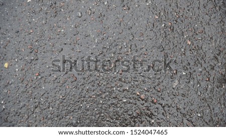 Texture and background of wet asphalt after rain in the autumn season