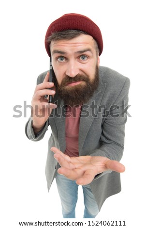 Say it with cell phone. Caucasian guy making a call with portable telephone or smartphone. Bearded man talking on mobile phone. Hipster using phone to talk on move.