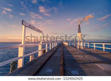 A fiery sunset over the top of the renowned Busselton jetty in Western Australia.