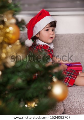 Cute child opens a christmas present