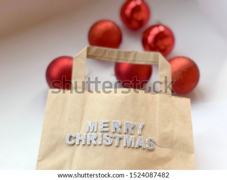 merry christmas greeting card. Shopping bag with Merry Christmas text and red decorative balls on white background. Christmas concept