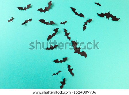 Halloween paper decorations on pastel blue  background. Halloween concept. Flat lay, top view, copy space
