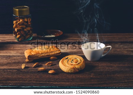 Pie and Denis Bread sweet food with hot coffee on wood background.