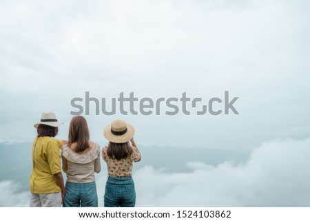 Vintage style picture. Mother and daughter trying to capture landscape scene with fog. Harmony and family concept. Travel to the mountian.