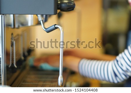 a barista is working in the cafe now she doing some cleaning the coffee machine before and after work.
