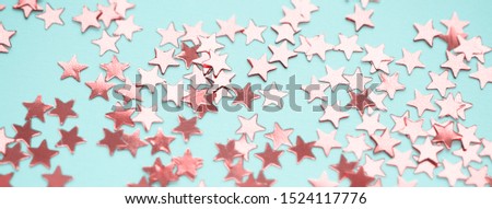 Golden stars glitter on blue background. Festive holiday bright backdrop. Social media banner or header.