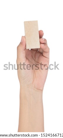 Hand holding wooden block isolated on white background