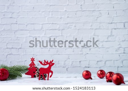 Christmas white background with decorations and papercraft reindeer on board.