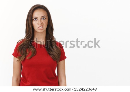 Annoyed displeased young woman in red t-shirt express scorn and disdain, smirk disgusted, bothered attend lame event, stare camera indifferent, irritated being here, stand white background