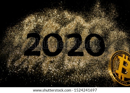 Happy New Year 2020 . Creative Collage of numbers two and zero made up the year 2020. Beautiful sparkling Golden number 2020 and bitcoin on black background for design.
