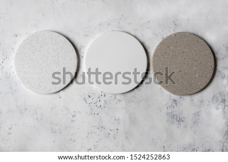 Round coasters made of artificial stone tabletop.  Food stand. Royalty-Free Stock Photo #1524252863