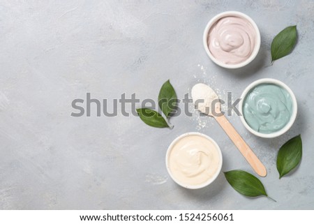 Clay mask set. Natural facial masks from white, pink and blue cosmetic clay top view.