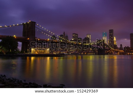 Brooklyn Bridge glowing in front of Manhattan skyline
