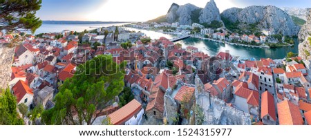 Panoramic views of the city, mountains and coast at sunset. Omis. Croatia.