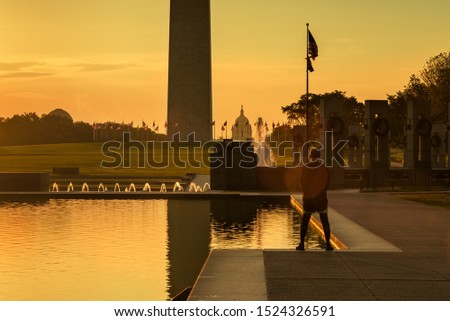Runner watching Washington DC skyline at sunrise, Reflecting pool in summer, Lifestyles traveller