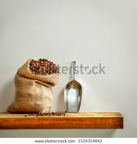 Fresh coffee and wooden brown shelf of free space for your decoration. Gray wall background of space for your text. 